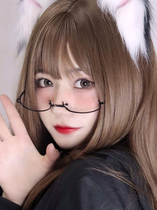 Close-up portrait of model wearing black half-frame lolita glasses with brown wig and cute cat ear hair clips, featuring soft makeup and vintage-inspired eyewear styling for lolita fashion