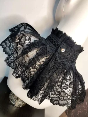 Black lace choker accessory side rear perspective showing ruffled edge metal button closure and eyelet decorated collar band on mannequin torso