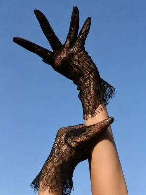 Black lace gothic gloves with eyelash fringe cuff trim displayed in upward angle shot, showing intricate floral lace texture and delicate frayed details against clear blue sky background, perfect for Lolita fashion styling