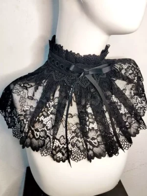 Black lace lolita choker collar with floral pattern and satin bow accent displayed on white mannequin front flat view showing scalloped ruffled trim design
