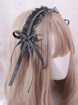 Black lace lolita headdress with silver-trimmed ruffles and black striped ribbon bow shown from rear view on mannequin head displaying elegant design