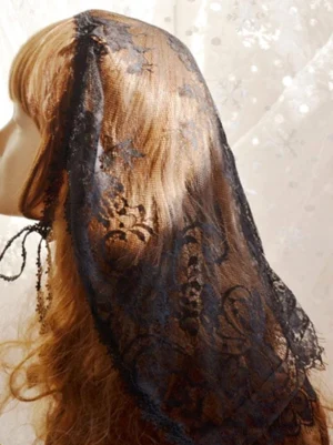 Right side profile of black lace lolita headdress veil displaying tassel edge ties and embossed floral pattern details on mannequin
