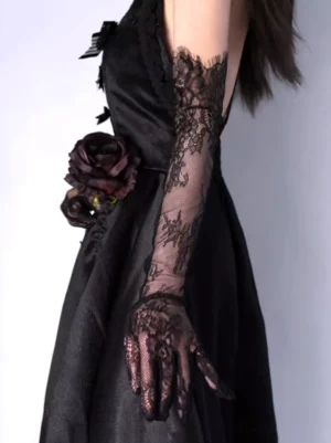 Side view of black lace gloves with rose ornament detail worn on black gothic dress showcasing elegant lace texture and arm length