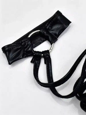 Black lace-up arm band flat lay top-down detail view showing faux leather material metal o-ring and tie laces on white background