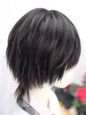 Black layered short lolita wig with tousled ends and side bangs, worn on mannequin with white shirt and black necktie, rear right angle view showing dimensional texture and flipped layered hair construction
