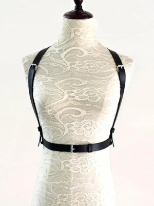 Chest harness belt with dual shoulder straps and silver metal buckles displayed on plain lace mannequin front view