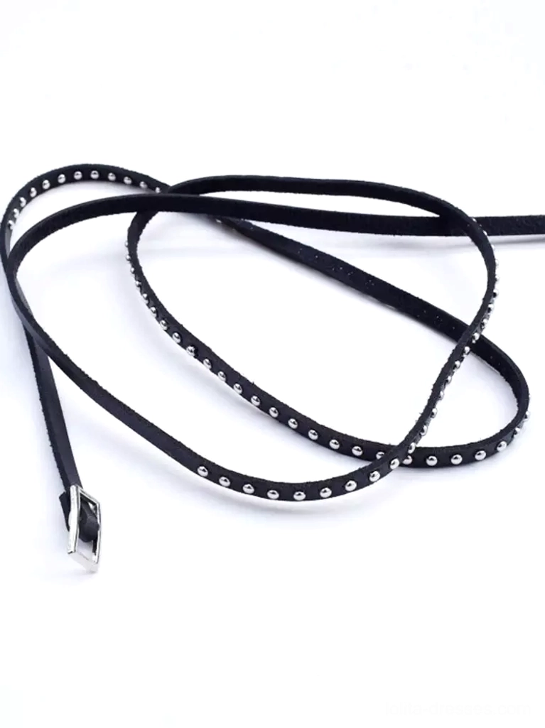 Long black leather punk arm strap accessory with silver rivet trim and metal adjustable buckle flat lay on white background, full product view showing complete design