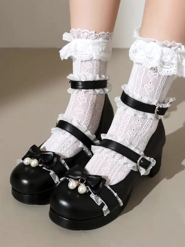 Black Lolita block heel Mary Jane pumps with pearl bow and dual buckle straps, front close-up on model wearing frilly white lace socks showing round matte toe