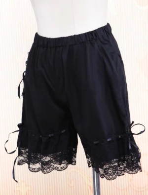 Black lolita bloomer shorts right side profile displaying ruffled lace hem, satin ribbon ties, and solid black cotton fabric construction on display stand