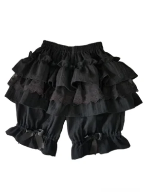 Black Lolita shorts flat lay photography showing full construction of multi-tier ruffled decoration, fine lace edging, and satin bow accents on gathered cuffs
