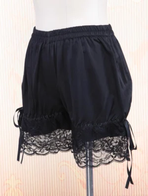 Side profile view of black cotton lolita bloomers featuring visible side ribbon tie and ruffled lace hem, displayed on mannequin