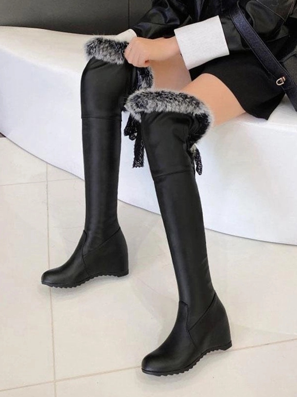 black lolita boots with grey fur cuff and back lace tassel detail high side view worn with black jacket