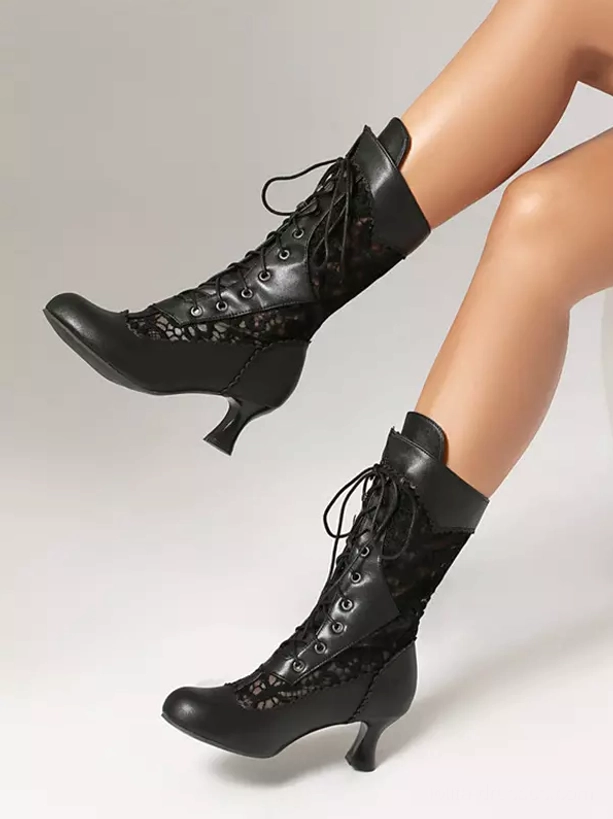 black lolita boots side view on feet showing lace panels low curved kitten heel studio background