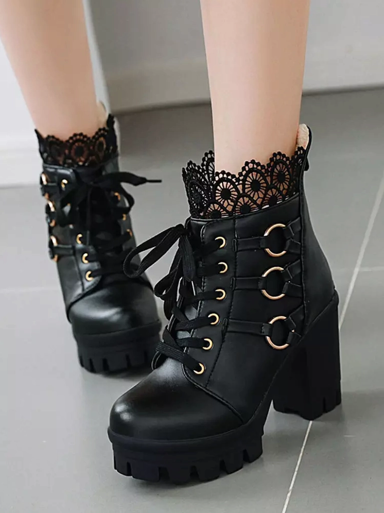 Model wearing black lace Gothic lolita ankle boots side view showing on-feet styling lace-up front platform block heel with tiled floor background