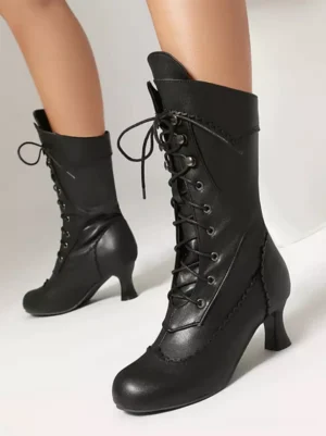 Black vintage lace-up mid-calf lolita boots with round toe and decorative stitching front three-quarter view on female model