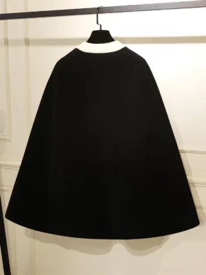 Black lolita cape coat back view showing solid fuzzy fabric and stand collar on clothing rack