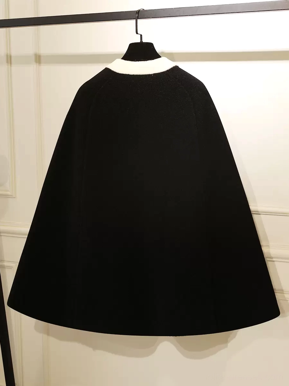 Black lolita cape coat back view showing solid fuzzy fabric and stand collar on clothing rack