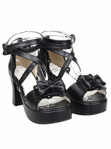 Black lolita sandals three-quarter side view showing scalloped shoe trim, cross ankle strap fastening, and decorative bow on peep toe design