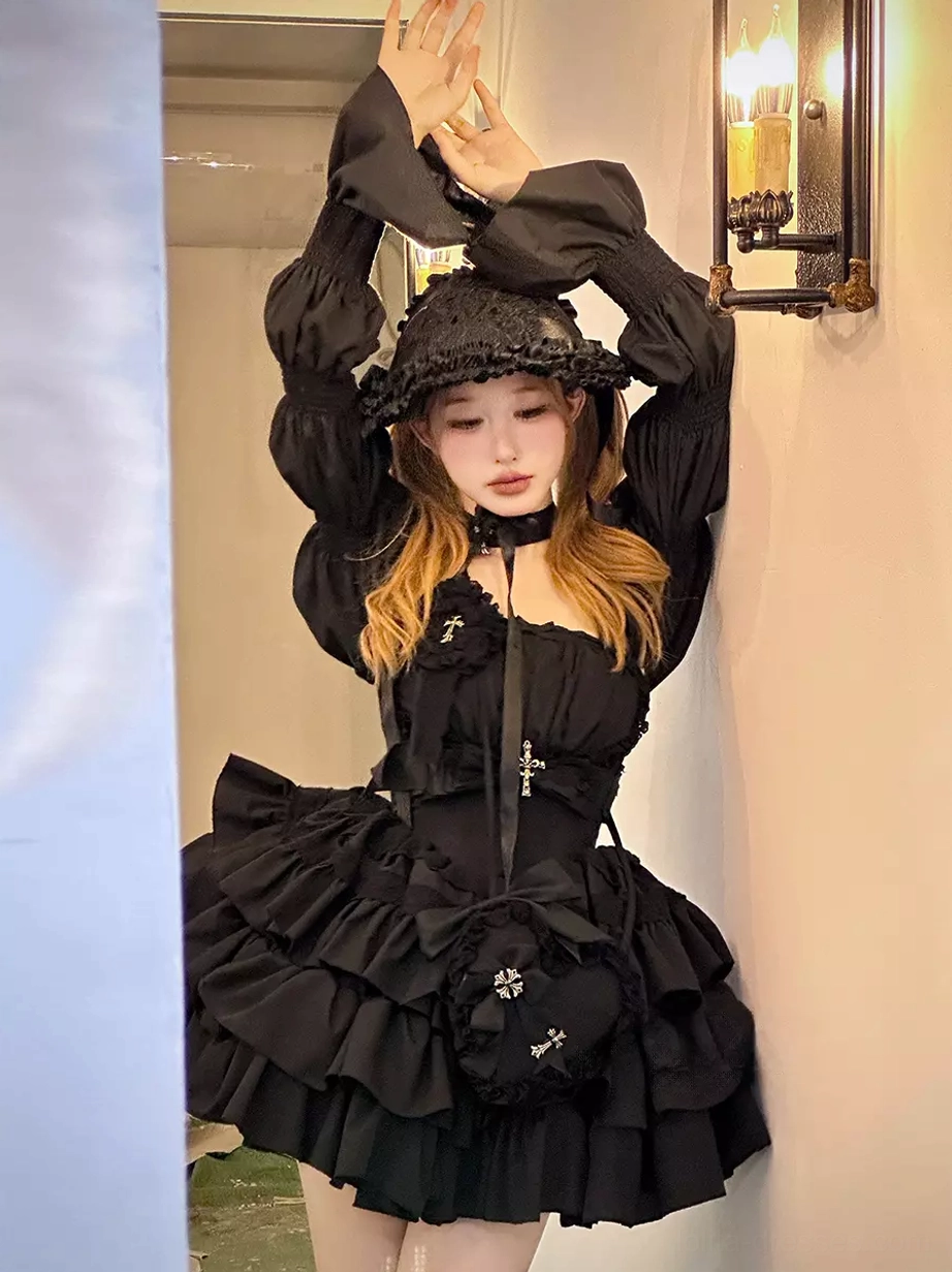 Model wearing complete black Gothic Lolita ensemble including dress with puff sleeves, ruffle bucket hat, cross details, matching black mini crossbody bag, indoor corridor setting, full coordinate view