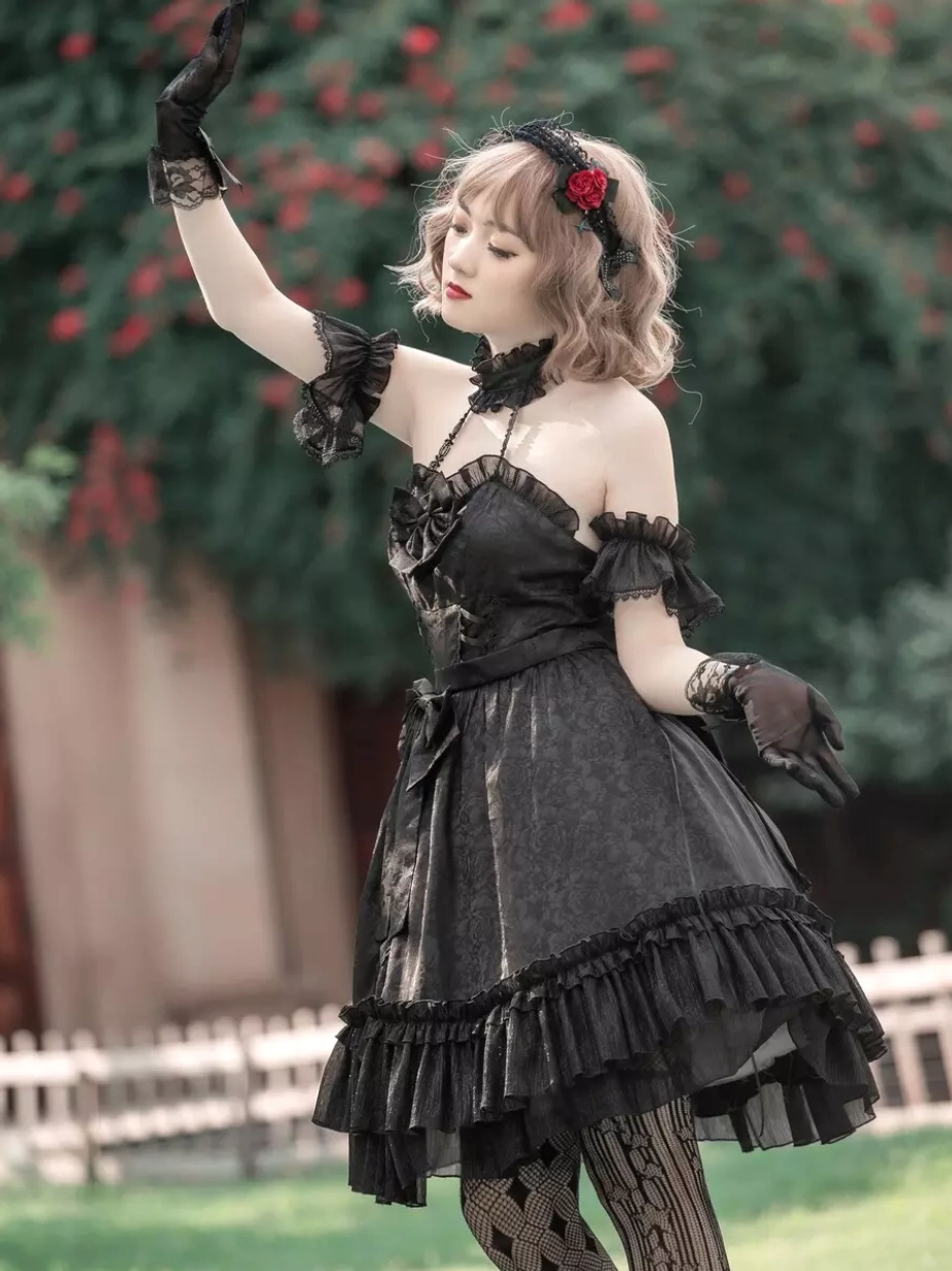 Black Gothic Lolita dress half-body side view featuring halter neck with choker, ruffled arm cuffs, and jacquard fabric texture detail