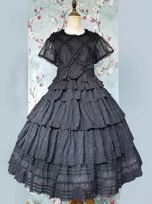 Black short-sleeve lolita dress with sheer lace sleeves and tiered ruffled skirt front flat shot on mannequin