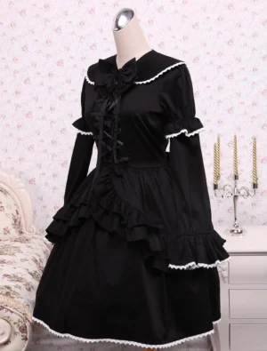 Side-front angle of black long-sleeve Lolita dress showing puffed sleeves with lace cuff trim and fitted bodice with flared ruffled hem