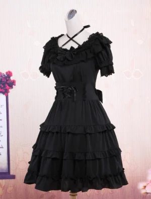 Black gothic lolita dress three-quarter angle view showing side bow sash tiered ruffle construction and authentic lolita silhouette