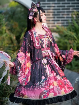 Three-quarter side view of black lolita kimono dress with floral print wide sleeves against brick wall and greenery