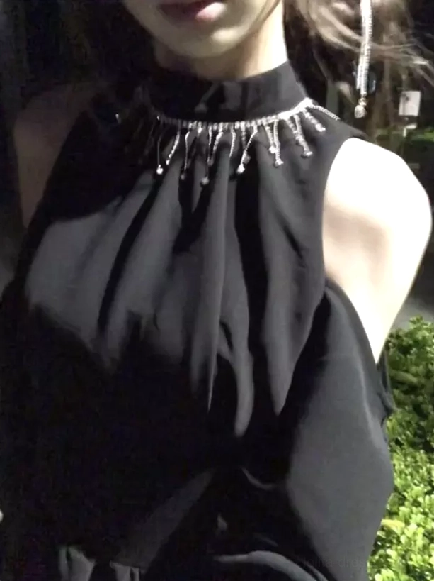 Front upper body close-up of black halter lolita dress featuring pleated bodice, cold-shoulder cut, and sparkling rhinestone tassel trim details