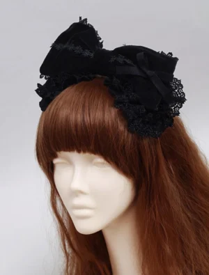 Full view of black lolita head bow accessory with puffy bow shape and scalloped lace edging worn on full mannequin displaying elegant silhouette and romantic styling