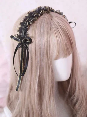 Classic black Lolita headdress with gold-trimmed ruffle lace and single black ribbon bow, displayed on mannequin with light brown wig, left side view