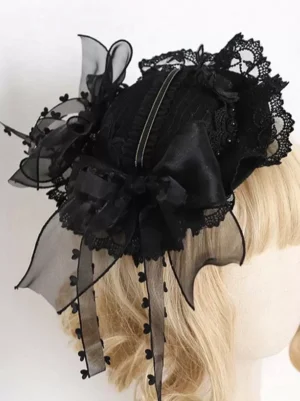 Back view of black gothic lolita headdress featuring large cascading bow, scalloped lace edge, and striped hat band, modeled on blonde wig from rear three-quarter perspective, displaying architectural construction detail
