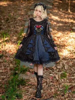 Full-body front view of black gothic lolita jumper skirt dress with sheer lace sleeves ruffled neckline and flared A-line skirt on model in autumn outdoor scene