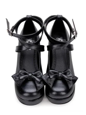 Black Lolita Mary Jane pumps with prominent front bow and crisscross ankle straps direct front view on pure white background, classic platform heel design