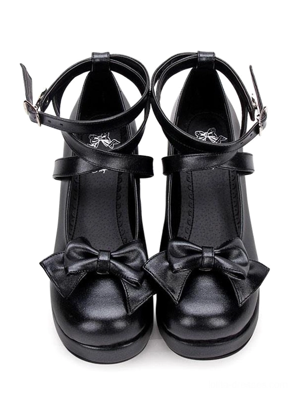 Black Lolita Mary Jane pumps with prominent front bow and crisscross ankle straps direct front view on pure white background, classic platform heel design