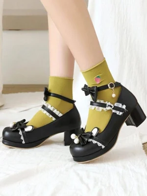 Black lolita Mary Jane shoes side profile with pearl-adorned bowknot, lace trim, chunky block heel, worn with yellow printed socks for sweet lolita aesthetic