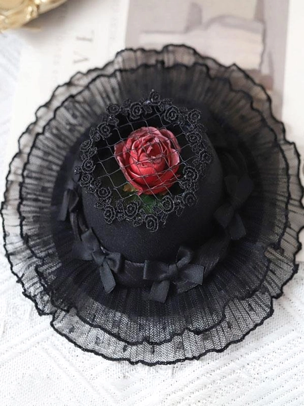 Black lolita mini headdress top-down close-up showing red rose layered black ruffle lace decorative bows