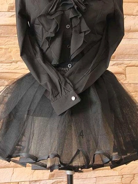 Black tulle petticoat paired with ruffled blouse full front view on dress form showing satin hemmed tulle skirt and ruffled design