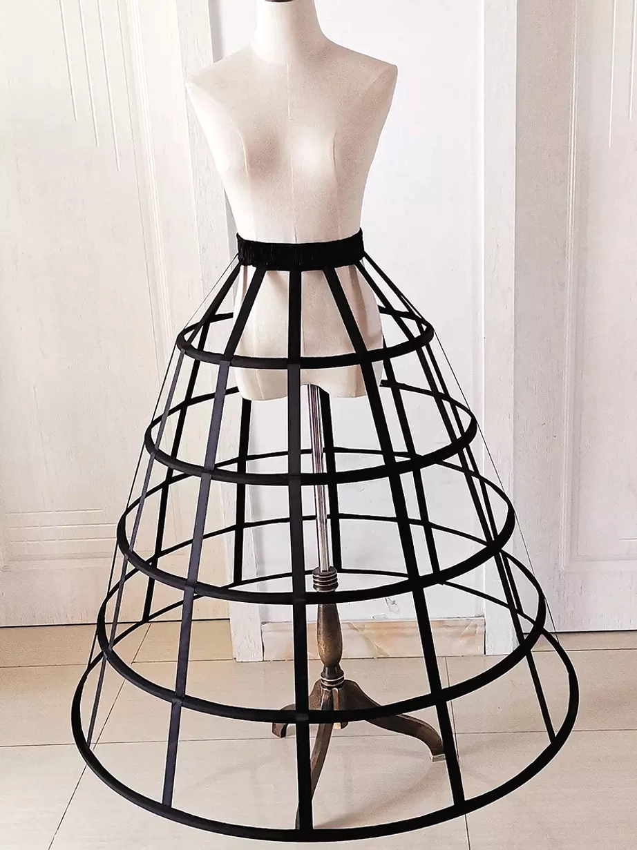 Black lolita petticoat side three-quarter angle view displaying multi-layer circular hoops and elastic waist structure