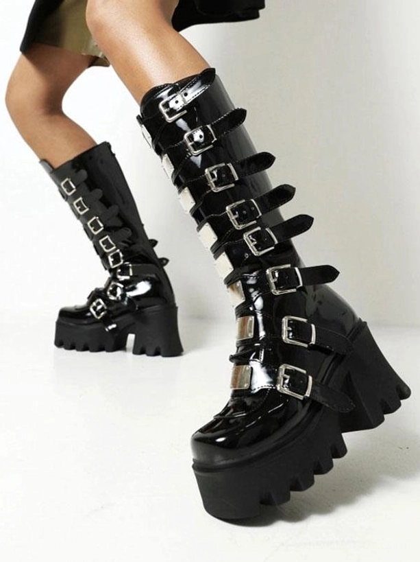 Black patent leather Lolita platform boots low front-side angle view on model featuring multiple silver buckles round toe design and glossy PU finish