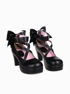 Black lolita platform heels front pair view with cross ankle straps and back bow decoration featuring pink insole detail