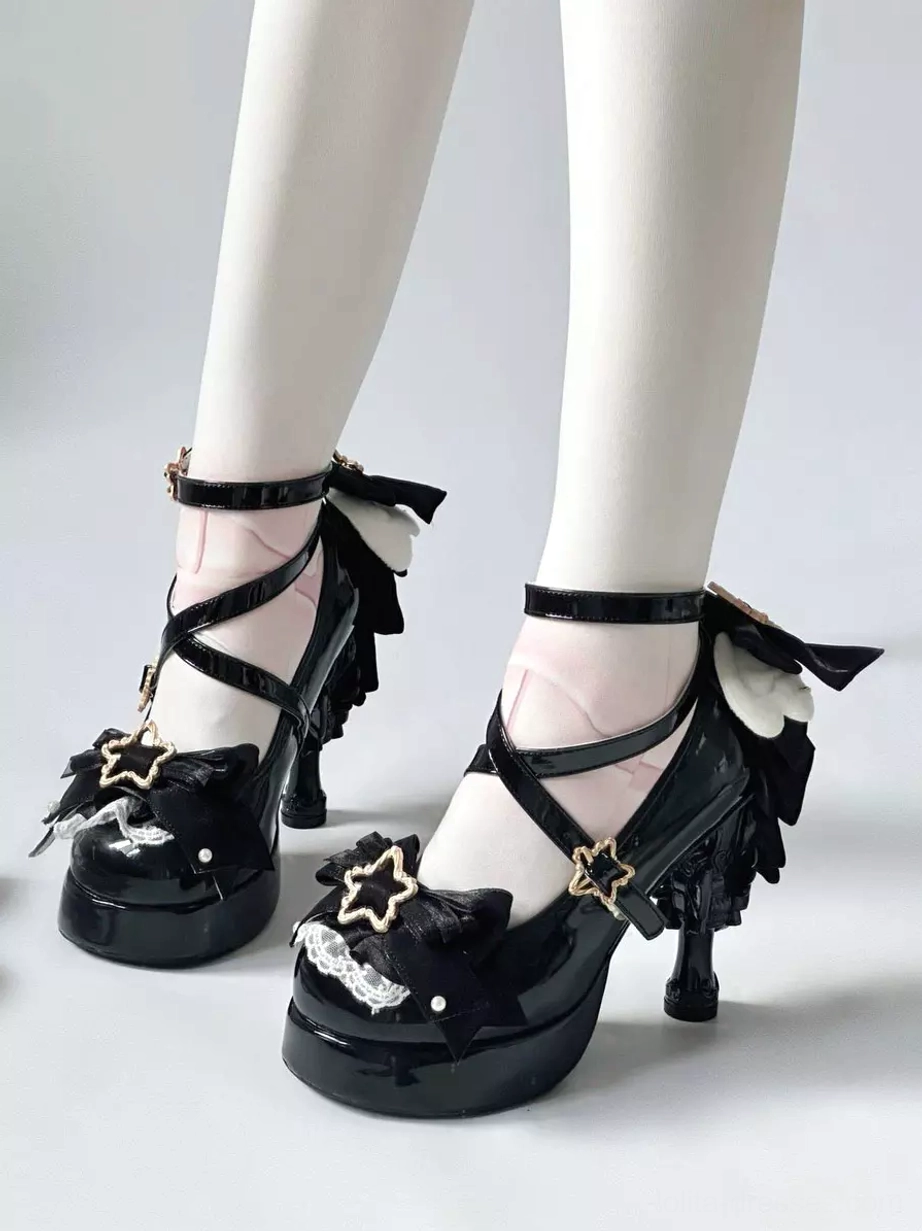 Black gothic lolita platform heels with patent leather finish, cross ankle straps, star buckles, and lace-trimmed back bow, side view profile