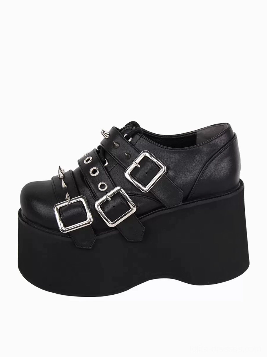 Single black gothic lolita platform pump three-quarter oblique view highlighting round toe shape, silver metallic studs and grommets, PU leather texture, and platform height