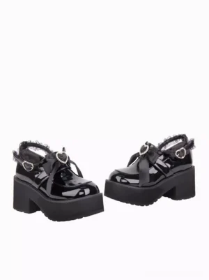 Top-down flat lay view of black lolita platform shoes showing chunky block heel structure, matching decorative hardware, and round toe silhouette design