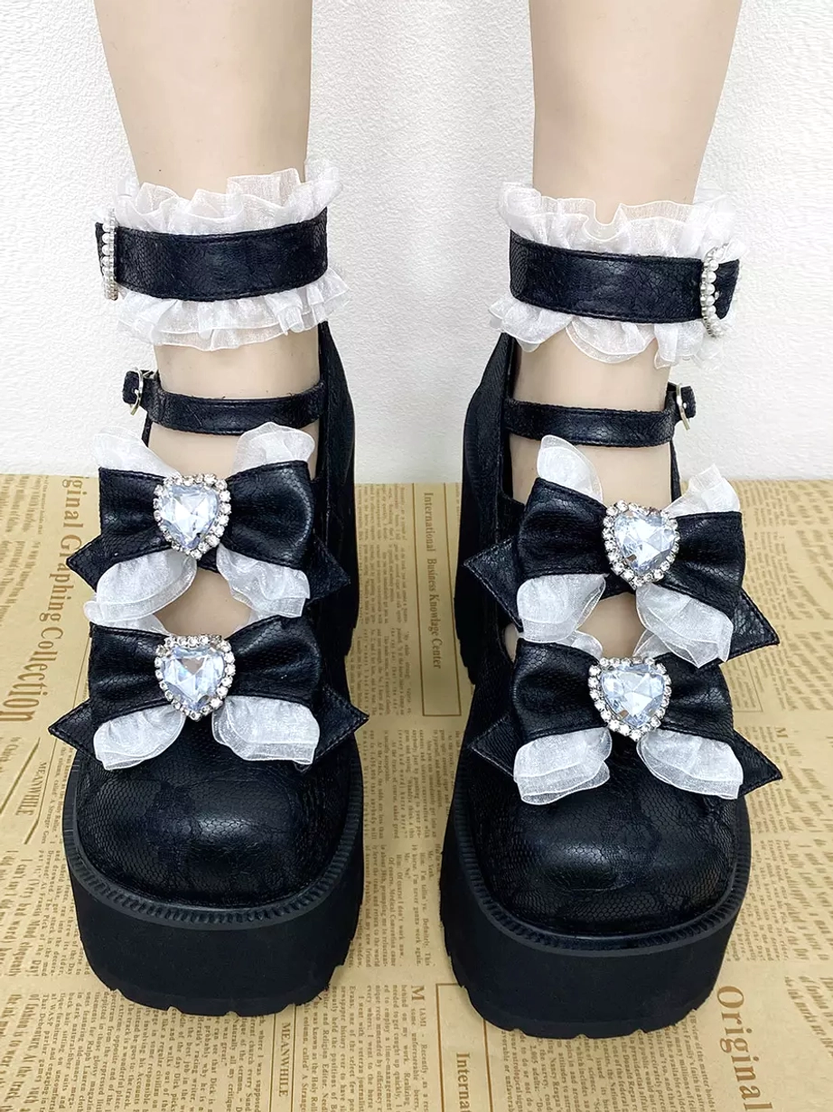 Styled lolita pumps worn on model legs with white ruffled ankle socks heart buckle straps and vintage newspaper print backdrop casual wear