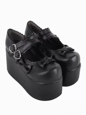 Black PU leather Lolita platform pumps side three-quarter view showcasing high wedge sole dual heart buckles and bow accents