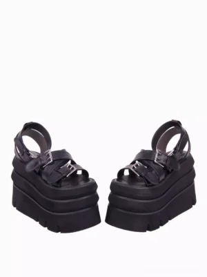 Black Lolita platform sandals side three-quarter view displaying adjustable metal buckles compact stacked platform sole architectural heel structure