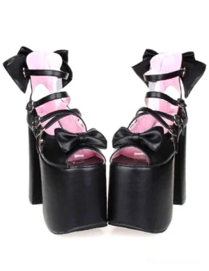 Black lolita platform sandals front paired view showing pink insole, front bowknot decoration, heart-shaped buckles, and chunky heel