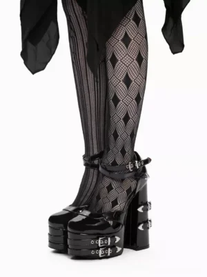 Black Gothic Lolita platform heel sandals front three-quarter angle displaying closed round toe design ankle strap buckles and shiny patent leather finish styled with argyle fishnet tights