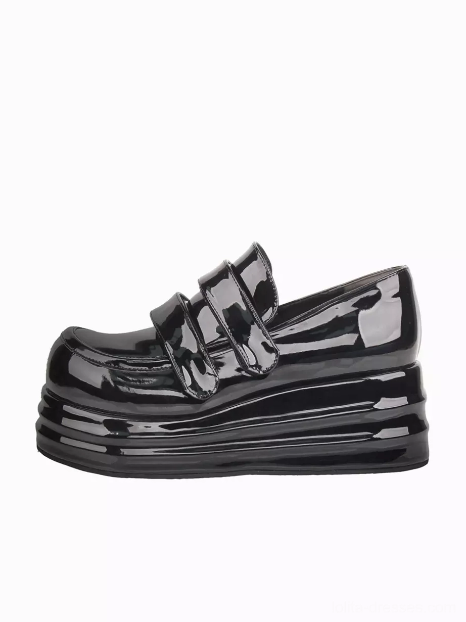 Single black patent leather Gothic Lolita platform shoe side three-quarter view showcasing layered thick sole construction and glossy finish